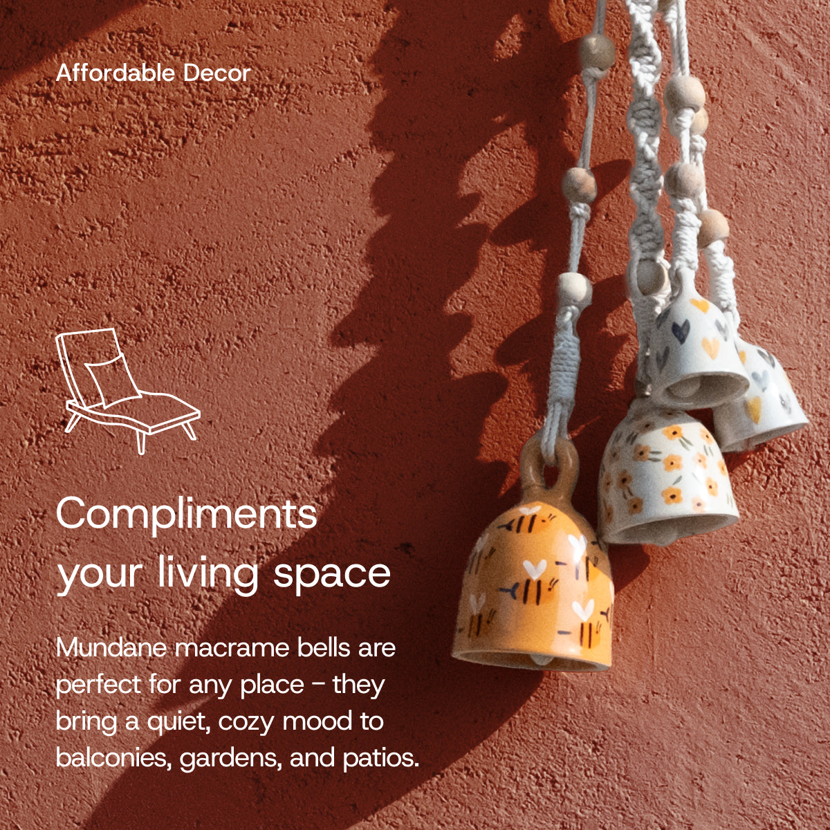 Four hand-painted ceramic macrame bells in warm tones, hanging from white knotted cords with wooden beads, casting shadows on a terracotta wall with text promoting affordable decor.