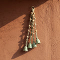 Decorative hanging bells against a textured wall